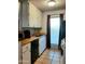 Kitchen with white cabinets, tiled floors, and a window at 1701 W Tuckey Ln # 134, Phoenix, AZ 85015