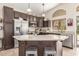 Modern kitchen with island, stainless steel appliances, and dark cabinetry at 17815 N 81St Way, Scottsdale, AZ 85255