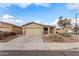 Tan house with a two-car garage and neatly landscaped front yard at 1944 E Saddle Dr, San Tan Valley, AZ 85143