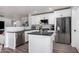 Modern kitchen with white cabinets, black countertops, and stainless steel appliances at 1944 E Saddle Dr, San Tan Valley, AZ 85143