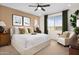 Spacious bedroom with large bed, sitting area, and window view at 20596 N 226Th Dr, Surprise, AZ 85387