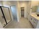 Clean, white bathroom features shower, cabinets and closet, with a modern design at 20596 N 226Th Dr, Surprise, AZ 85387