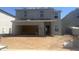 Two-story house under construction, attached garage, and dirt landscaping at 24206 W Hidalgo Ave, Buckeye, AZ 85326