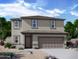 Two-story house with neutral exterior, attached garage, and landscaping at 24206 W Hidalgo Ave, Buckeye, AZ 85326