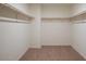 Spacious walk-in closet with double hanging rods at 24206 W Hidalgo Ave, Buckeye, AZ 85326