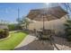 Landscaped backyard with patio furniture under an umbrella at 2931 E Citrus Way, Chandler, AZ 85286