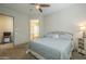 Comfortable bedroom with ensuite bathroom access and ceiling fan at 2931 E Citrus Way, Chandler, AZ 85286