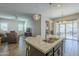 Open concept kitchen with granite island, stainless steel appliances, and backyard view at 2931 E Citrus Way, Chandler, AZ 85286