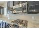 Stainless steel range and microwave in modern kitchen with granite countertops at 2931 E Citrus Way, Chandler, AZ 85286