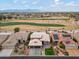 Aerial view of house with two-car garage, landscaping, and golf course view at 3182 N 159Th Dr, Goodyear, AZ 85395