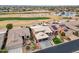 Aerial view of house with solar panels, landscaping, and golf course view at 3182 N 159Th Dr, Goodyear, AZ 85395