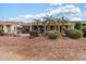 Landscaped backyard with pergola covered patio and mature plants at 3182 N 159Th Dr, Goodyear, AZ 85395