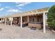 Spacious backyard patio with pergola, hot tub, and seating area at 3182 N 159Th Dr, Goodyear, AZ 85395