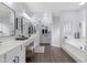 Elegant bathroom featuring double sinks, soaking tub and shower at 3182 N 159Th Dr, Goodyear, AZ 85395