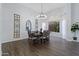Bright dining room features a large table, chandelier, and hardwood floors at 3182 N 159Th Dr, Goodyear, AZ 85395