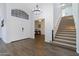 Bright and spacious entryway with elegant chandelier and staircase at 3182 N 159Th Dr, Goodyear, AZ 85395