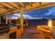 Evening view of patio with grill and fire pit, overlooking golf course at 3182 N 159Th Dr, Goodyear, AZ 85395