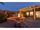 Outdoor patio with fire pit and built-in barbecue area at 3182 N 159Th Dr, Goodyear, AZ 85395