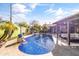 Sparkling pool with waterfall feature, pergola-covered seating area, and lush landscaping at 3519 N Pinto Ln, Scottsdale, AZ 85251