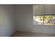 Bright bedroom with a window offering a view of the neighborhood at 4127 E Maldonado Dr, Phoenix, AZ 85042