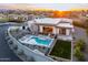Aerial view of a modern home with pool, outdoor kitchen and living area, set in a well-manicured landscape at 4414 E Vermont S Ave, Phoenix, AZ 85018