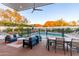 Outdoor patio with plush seating, dining table, fan and a pool view, perfect for entertaining and relaxation at 4414 E Vermont S Ave, Phoenix, AZ 85018