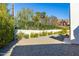 Well-maintained gravel backyard featuring lush greenery and privacy wall, perfect for outdoor enjoyment at 4414 E Vermont S Ave, Phoenix, AZ 85018