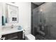 Stylish bathroom with modern vanity, walk-in shower, and black and white patterned floor tiles at 4414 E Vermont S Ave, Phoenix, AZ 85018