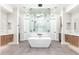 Stunning bathroom featuring a stand-alone tub and large walk-in shower with and vanities at 4414 E Vermont S Ave, Phoenix, AZ 85018