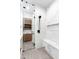 Elegant bathroom with a glass-enclosed shower featuring a built-in bench, tile design and natural lighting at 4414 E Vermont S Ave, Phoenix, AZ 85018