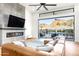Bright living room boasts modern fireplace, leather sectional, and indoor/outdoor living with mountain views at 4414 E Vermont S Ave, Phoenix, AZ 85018