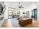 Modern living room featuring a sectional sofa, fireplace, and sliding glass doors at 4414 E Vermont S Ave, Phoenix, AZ 85018