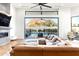 Open-concept living room features fireplace and a large sliding door to the outdoor pool and lounge area at 4414 E Vermont S Ave, Phoenix, AZ 85018