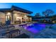 Modern home boasts a beautiful backyard swimming pool illuminated with vibrant purple lighting at 4414 E Vermont S Ave, Phoenix, AZ 85018