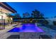 Backyard pool with illuminated water, complemented by manicured landscaping and a modern home design at 4414 E Vermont S Ave, Phoenix, AZ 85018