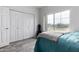 Bedroom with golf course view and teal bedding at 4455 E Paradise Village S Pkwy # 1031, Phoenix, AZ 85032
