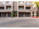 Building exterior featuring multiple units with attached garages and a well-maintained courtyard at 4455 E Paradise Village S Pkwy # 1031, Phoenix, AZ 85032