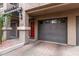 Private entrance with attached garage and a red front door at 4455 E Paradise Village S Pkwy # 1031, Phoenix, AZ 85032