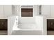 Modern bathroom with separate vanities and soaking tub under a window at 4828 N 177Th Ln, Goodyear, AZ 85395