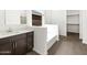 Bright bathroom features a soaking tub, dark wood vanity, and modern fixtures at 4828 N 177Th Ln, Goodyear, AZ 85395