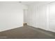 An airy bedroom with carpet and double closet doors for storage at 4828 N 177Th Ln, Goodyear, AZ 85395