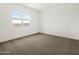 The bedroom has large windows and carpet for comfort at 4828 N 177Th Ln, Goodyear, AZ 85395