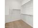Walk-in closet has carpeted floors and ample storage with shelving and clothing rods at 4828 N 177Th Ln, Goodyear, AZ 85395