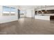 Open-concept living room featuring wood-look tile and views into the kitchen at 4828 N 177Th Ln, Goodyear, AZ 85395