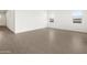 Bright living room showcasing neutral walls and wood-look tile flooring at 4828 N 177Th Ln, Goodyear, AZ 85395