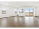 Well-lit living room with wood-look flooring and sliding glass door to backyard at 4828 N 177Th Ln, Goodyear, AZ 85395