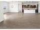 Open-concept living space featuring kitchen with dark wood cabinets and tile flooring at 4828 N 177Th Ln, Goodyear, AZ 85395