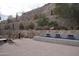Backyard landscape featuring stone retaining wall and tiered fountain at 5000 N Camelback Ridge Rd # 109, Scottsdale, AZ 85251