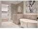 Elegant bathroom with a freestanding tub, glass-enclosed shower, and sophisticated tile design at 5000 N Camelback Ridge Rd # 109, Scottsdale, AZ 85251