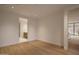 Bright bedroom featuring light hardwood flooring, white walls and access to en-suite bathroom at 5000 N Camelback Ridge Rd # 109, Scottsdale, AZ 85251